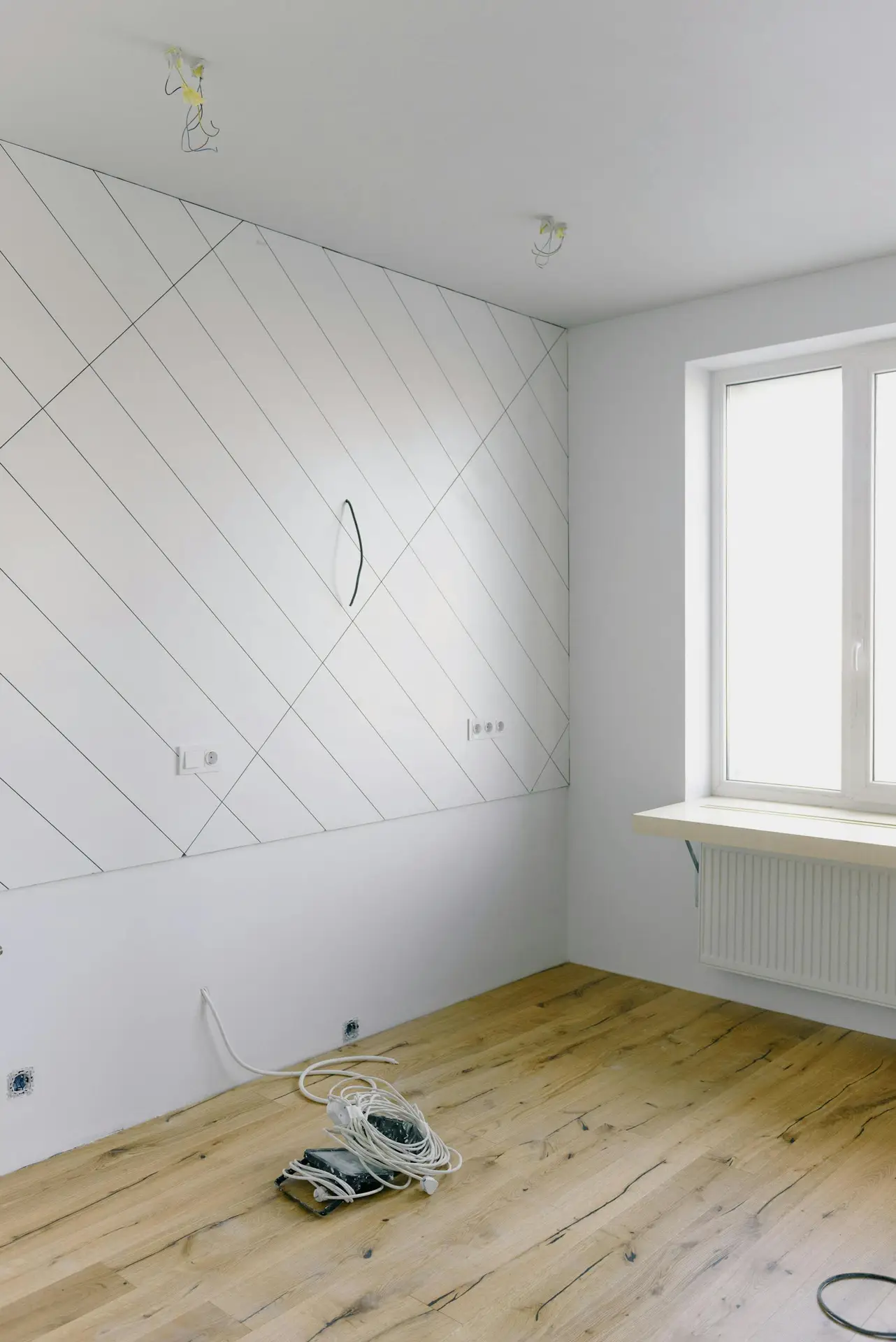Electrical and installation work in light empty room with big window and new design